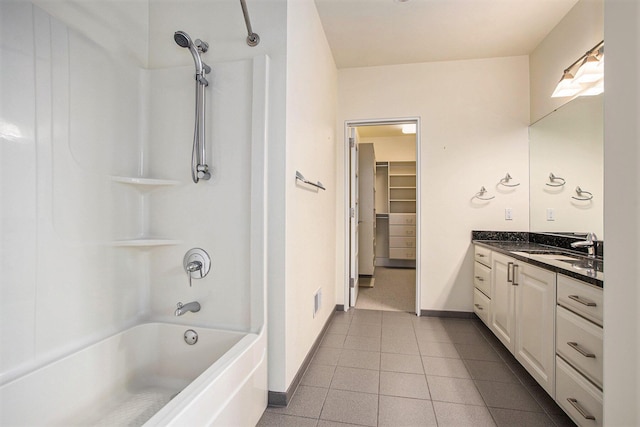 20 Hiawatha Dr, Battle Creek, MI 49015 - bathroom featuring vanity, tile patterned flooring, shower / bath combination, and a spacious closet