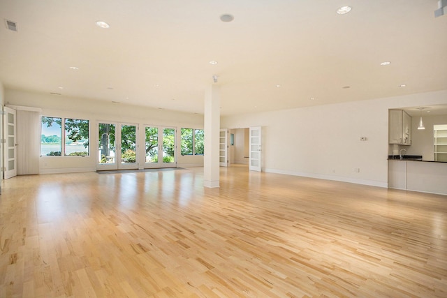 20 Hiawatha Dr, Battle Creek, MI 49015 - unfurnished living room featuring light wood finished floors and recessed lighting