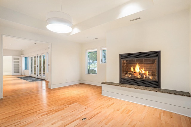 20 Hiawatha Dr, Battle Creek, MI 49015 - unfurnished living room featuring light wood-style flooring and a glass covered fireplace