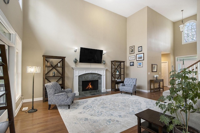 5371 S 4th St, Kalamazoo, MI 49009 - living area featuring a high ceiling, a high end fireplace, dark wood-type flooring, and baseboards