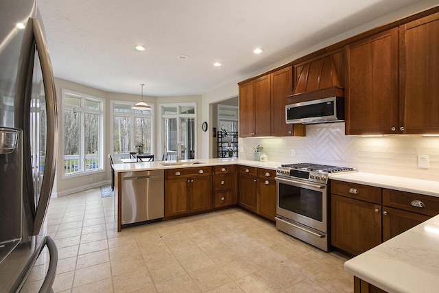 5371 S 4th St, Kalamazoo, MI 49009 - kitchen with stainless steel appliances, a sink, a peninsula, light countertops, and recessed lighting