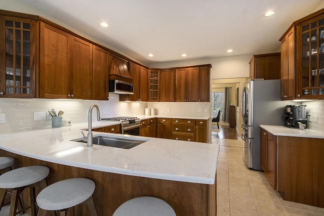 5371 S 4th St, Kalamazoo, MI 49009 - kitchen featuring a sink, a peninsula, backsplash, recessed lighting, and glass insert cabinets