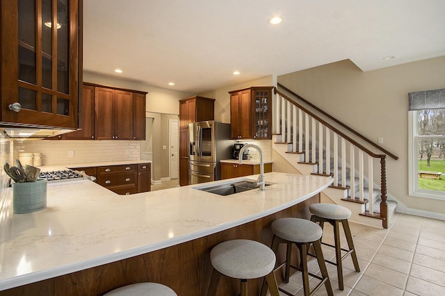 5371 S 4th St, Kalamazoo, MI 49009 - kitchen with a sink, stainless steel fridge with ice dispenser, backsplash, light tile patterned flooring, and glass insert cabinets