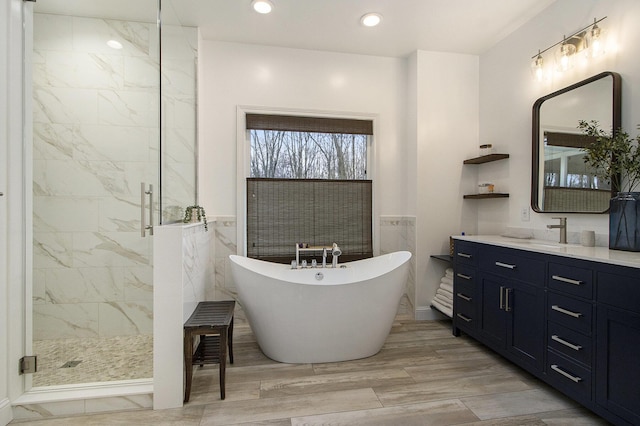 5371 S 4th St, Kalamazoo, MI 49009 - bathroom with a soaking tub, a shower stall, vanity, wood finished floors, and recessed lighting