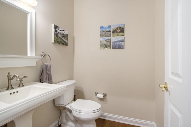 5371 S 4th St, Kalamazoo, MI 49009 - bathroom featuring a sink, baseboards, toilet, and wood finished floors