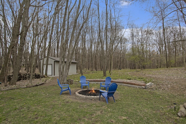 5371 S 4th St, Kalamazoo, MI 49009 - view of green lawn featuring a fire pit, an outdoor structure, and a garage