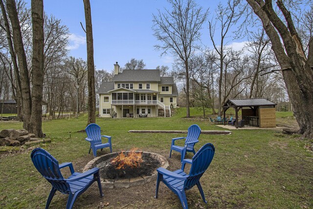 5371 S 4th St, Kalamazoo, MI 49009 - view of grassy yard featuring a fire pit, a gazebo, a deck, stairway, and a patio