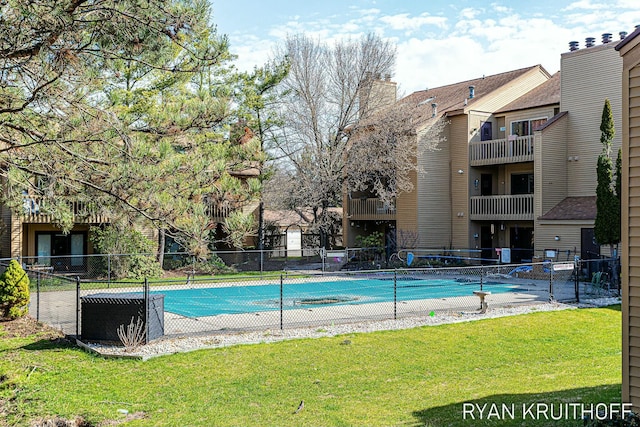 pool with fence and a yard
