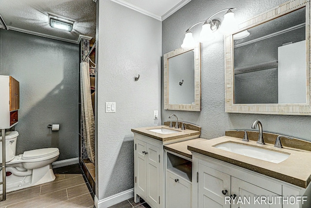 bathroom with a textured wall, toilet, ornamental molding, and a sink