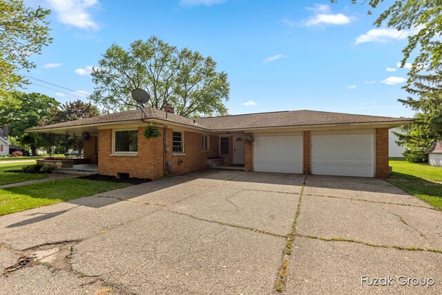 4733 136th Ave, Hamilton, MI 49419 - ranch-style house featuring brick siding, a garage, concrete driveway, and a front lawn