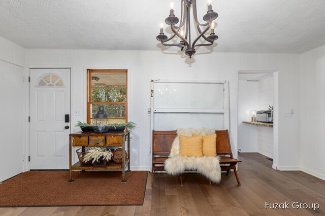 4733 136th Ave, Hamilton, MI 49419 - entrance foyer featuring a chandelier, wood finished floors, and a textured ceiling