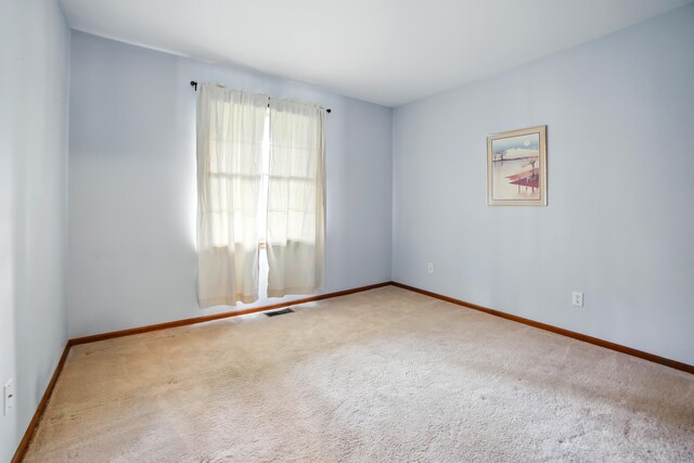 256 Bona Vista Dr NW, Grand Rapids, MI 49504 - carpeted spare room with baseboards and visible vents