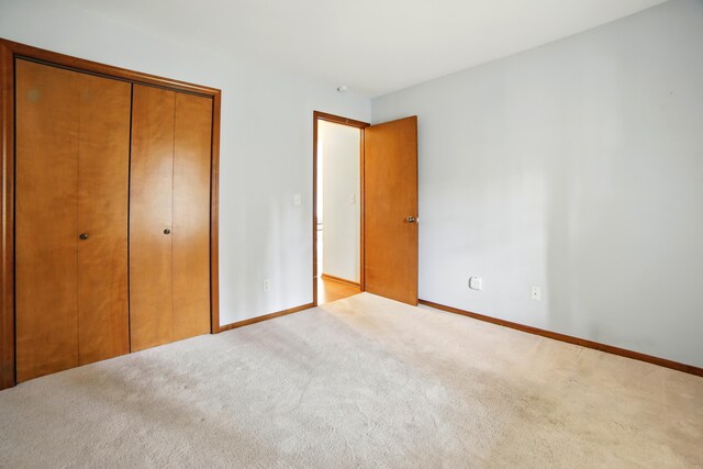 256 Bona Vista Dr NW, Grand Rapids, MI 49504 - unfurnished bedroom with baseboards, carpet flooring, and a closet
