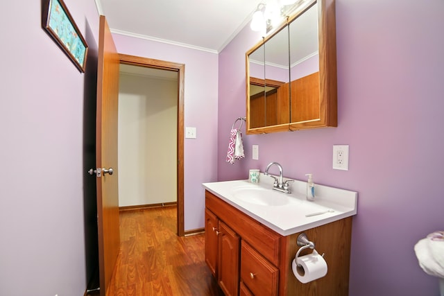 256 Bona Vista Dr NW, Grand Rapids, MI 49504 - bathroom with ornamental molding, vanity, and wood finished floors