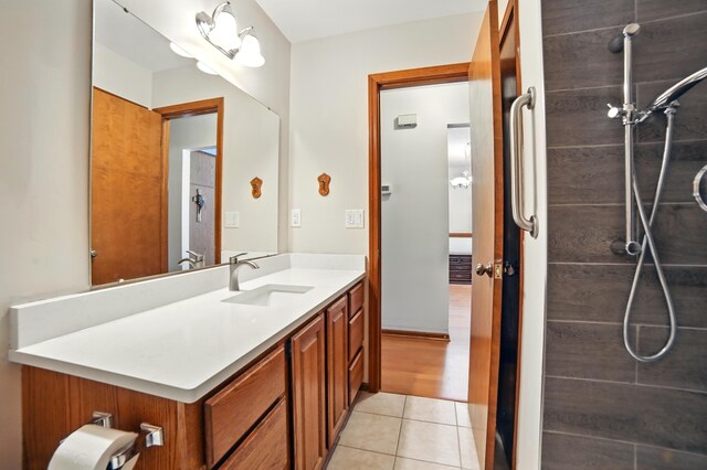 256 Bona Vista Dr NW, Grand Rapids, MI 49504 - full bathroom with tile patterned floors, vanity, and tiled shower