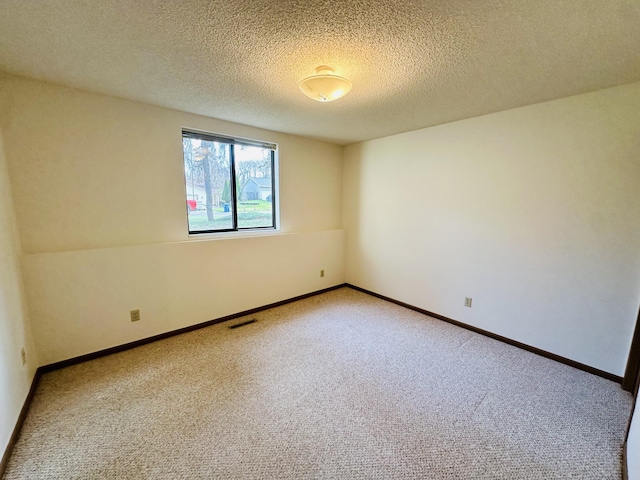 1049 Leroux Rd, Muskegon, MI 49441 - unfurnished room with baseboards, carpet flooring, a textured ceiling, and visible vents