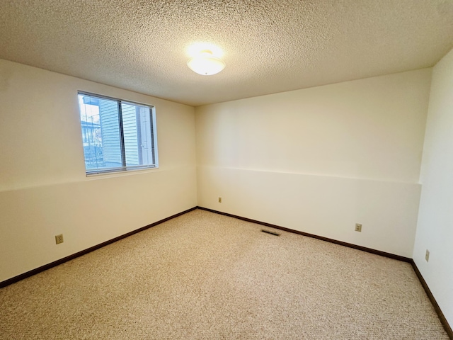 1049 Leroux Rd, Muskegon, MI 49441 - empty room with a textured ceiling, light colored carpet, baseboards, and visible vents