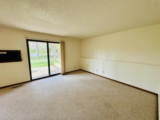 1049 Leroux Rd, Muskegon, MI 49441 - carpeted empty room with baseboards, a wall mounted air conditioner, and a textured ceiling