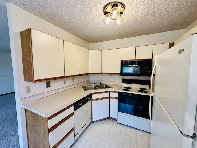 1049 Leroux Rd, Muskegon, MI 49441 - kitchen with white appliances, light countertops, a textured ceiling, white cabinets, and a sink