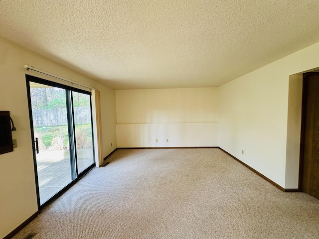 1049 Leroux Rd, Muskegon, MI 49441 - carpeted spare room with baseboards and a textured ceiling
