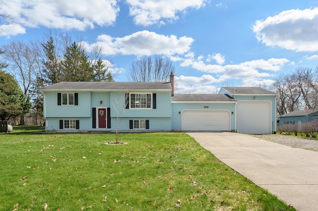 8524 E B Ave, Richland, MI 49083 - bi-level home with a garage, concrete driveway, a chimney, and a front lawn