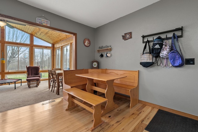 8524 E B Ave, Richland, MI 49083 - dining area with vaulted ceiling, light wood finished floors, baseboards, a ceiling fan, and a textured wall