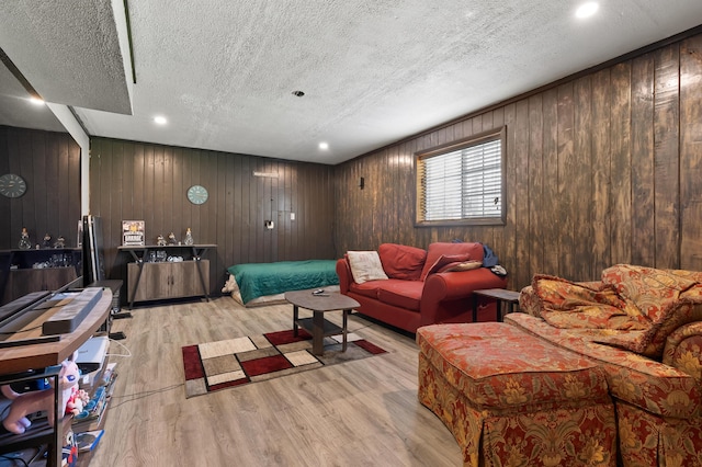 8524 E B Ave, Richland, MI 49083 - living area with light wood-type flooring, a textured ceiling, wood walls, and recessed lighting