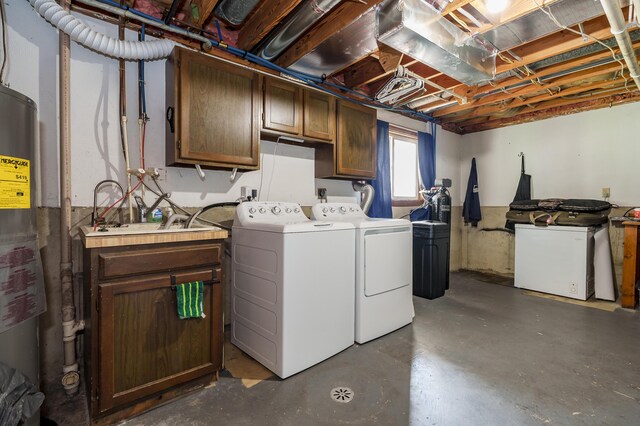 8524 E B Ave, Richland, MI 49083 - laundry area featuring washer and clothes dryer, cabinet space, and water heater