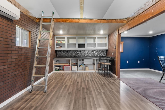 8524 E B Ave, Richland, MI 49083 - bar area featuring a wall unit AC, brick wall, baseboards, wood finished floors, and recessed lighting