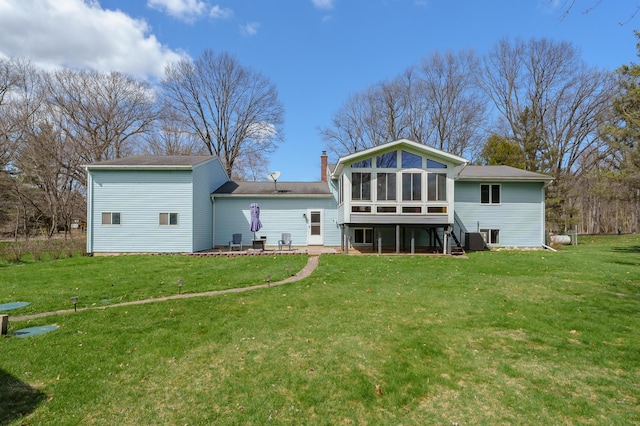 8524 E B Ave, Richland, MI 49083 - back of house with a sunroom, a lawn, central AC, and a chimney