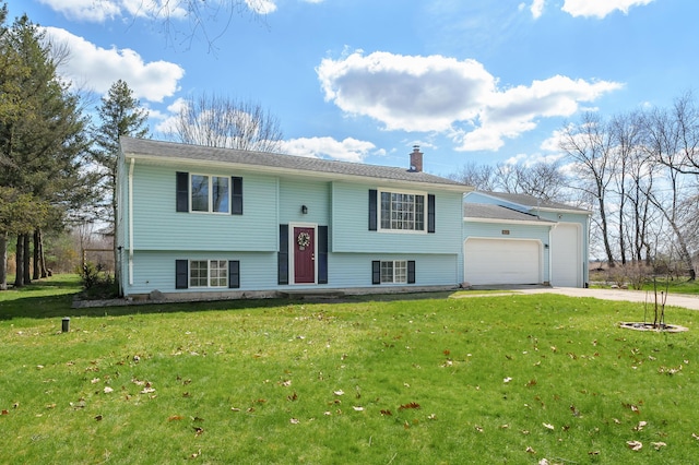 8524 E B Ave, Richland, MI 49083 - split foyer home with a chimney, an attached garage, driveway, and a front yard