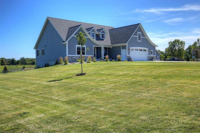 4459 36th St, Hamilton, MI 49419 - craftsman-style home featuring stone siding, a shingled roof, and a front lawn