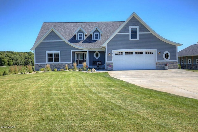 4459 36th St, Hamilton, MI 49419 - view of front of property with a garage, driveway, stone siding, and a front yard