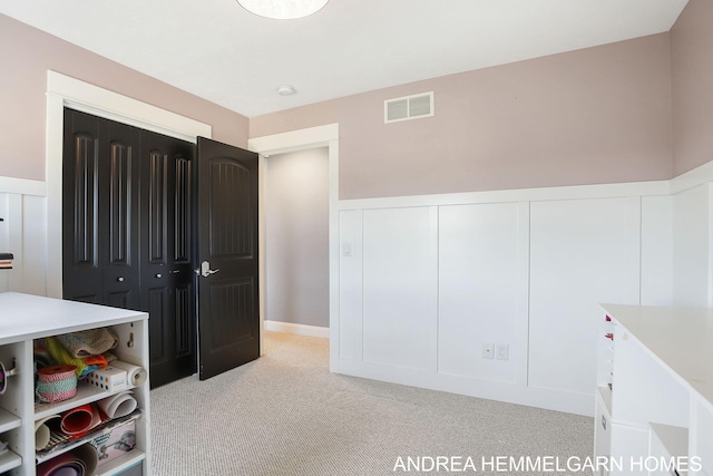 4459 36th St, Hamilton, MI 49419 - unfurnished bedroom with a closet, visible vents, light colored carpet, and wainscoting