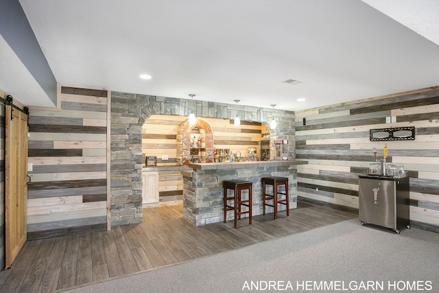 4459 36th St, Hamilton, MI 49419 - bar featuring a barn door, visible vents, a bar, wood finished floors, and wood walls
