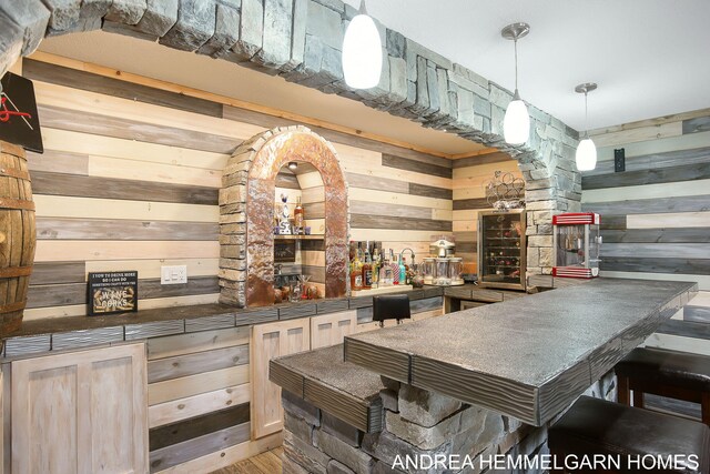 4459 36th St, Hamilton, MI 49419 - bar featuring a bar, wood finished floors, wooden walls, decorative light fixtures, and ornate columns