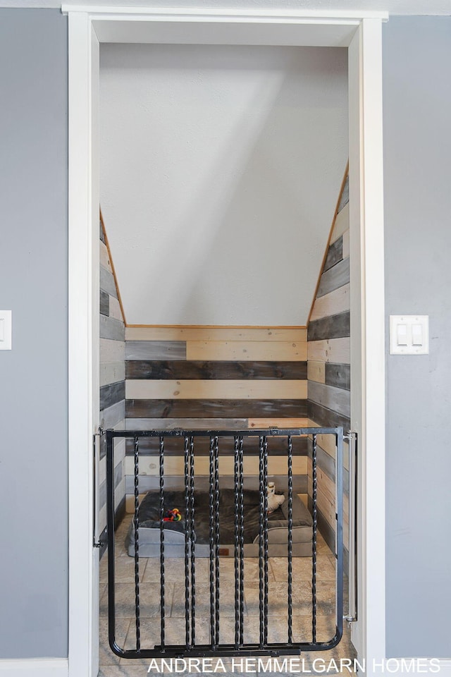 4459 36th St, Hamilton, MI 49419 - stairway featuring lofted ceiling and wooden walls
