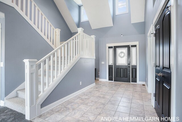 4459 36th St, Hamilton, MI 49419 - foyer featuring baseboards, a high ceiling, and stairway
