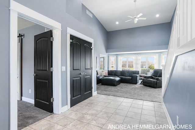 4459 36th St, Hamilton, MI 49419 - hallway featuring baseboards, light carpet, a towering ceiling, and light tile patterned floors