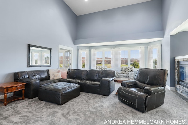 4459 36th St, Hamilton, MI 49419 - living area with a stone fireplace, a towering ceiling, and carpet