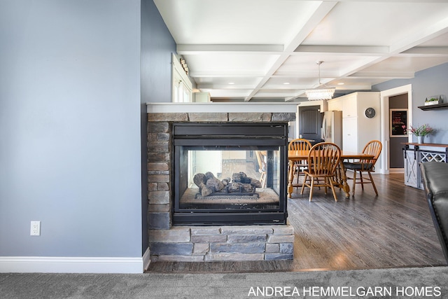 4459 36th St, Hamilton, MI 49419 - room details featuring beamed ceiling, baseboards, coffered ceiling, and a multi sided fireplace