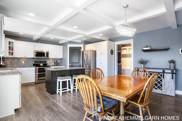 4459 36th St, Hamilton, MI 49419 - dining space with beam ceiling, an inviting chandelier, coffered ceiling, and dark wood-style flooring