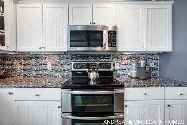 4459 36th St, Hamilton, MI 49419 - kitchen with stainless steel appliances, dark stone countertops, backsplash, and white cabinetry