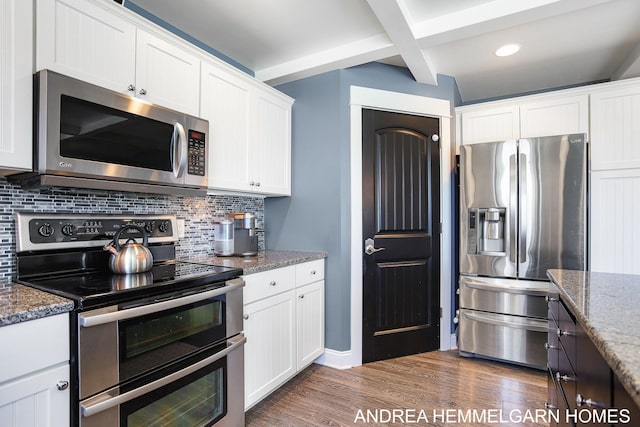 4459 36th St, Hamilton, MI 49419 - kitchen with white cabinets, decorative backsplash, and appliances with stainless steel finishes