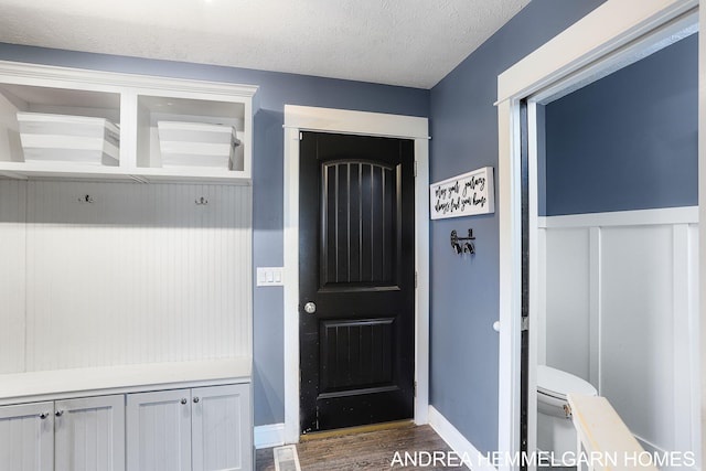 4459 36th St, Hamilton, MI 49419 - mudroom featuring wood finished floors, a textured ceiling, a wainscoted wall, and visible vents