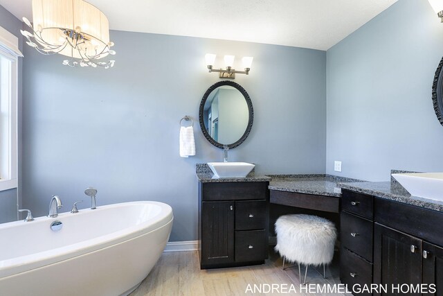 4459 36th St, Hamilton, MI 49419 - full bath with baseboards, a soaking tub, vanity, and an inviting chandelier