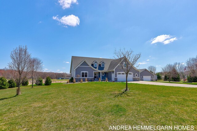 4459 36th St, Hamilton, MI 49419 - view of front of home featuring driveway, stone siding, covered porch, an attached garage, and a front yard