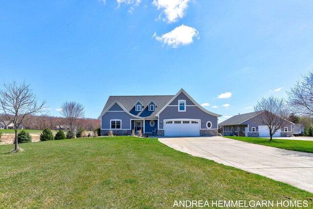 4459 36th St, Hamilton, MI 49419 - view of front of property with concrete driveway, a front lawn, stone siding, and an attached garage