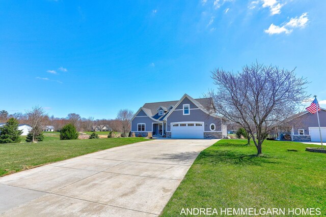 4459 36th St, Hamilton, MI 49419 - view of front of home featuring stone siding, a front lawn, driveway, and a garage