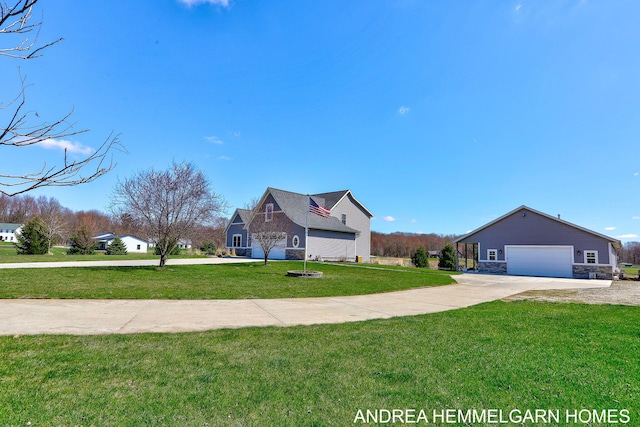 4459 36th St, Hamilton, MI 49419 - view of front facade with stone siding, driveway, a front yard, and a garage